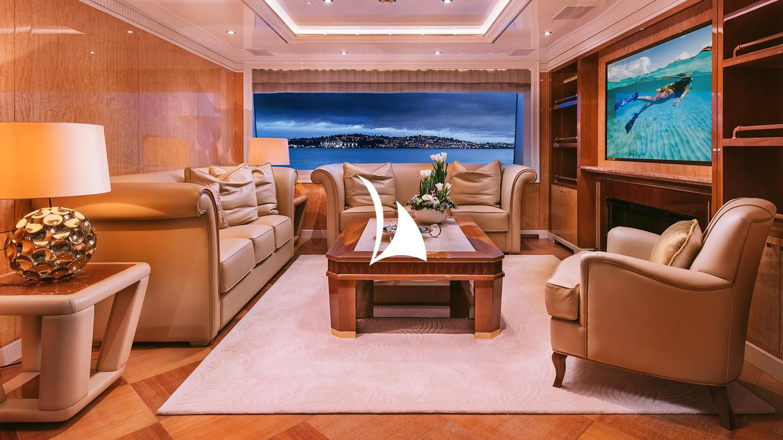 a living room with a large screen aboard AELIA Yacht for Sale