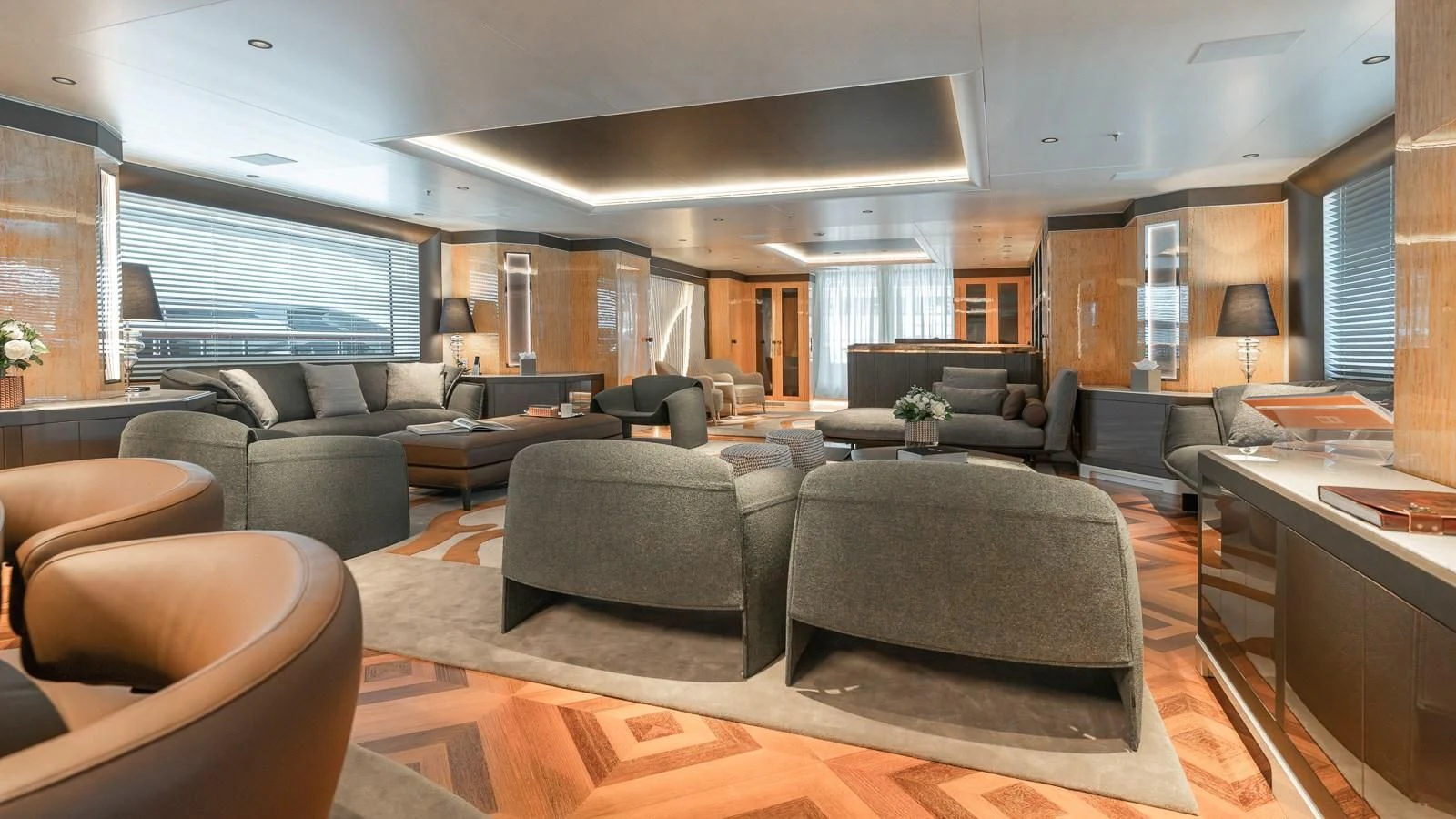 a large living room with leather couches and a large window aboard AELIA Yacht for Sale