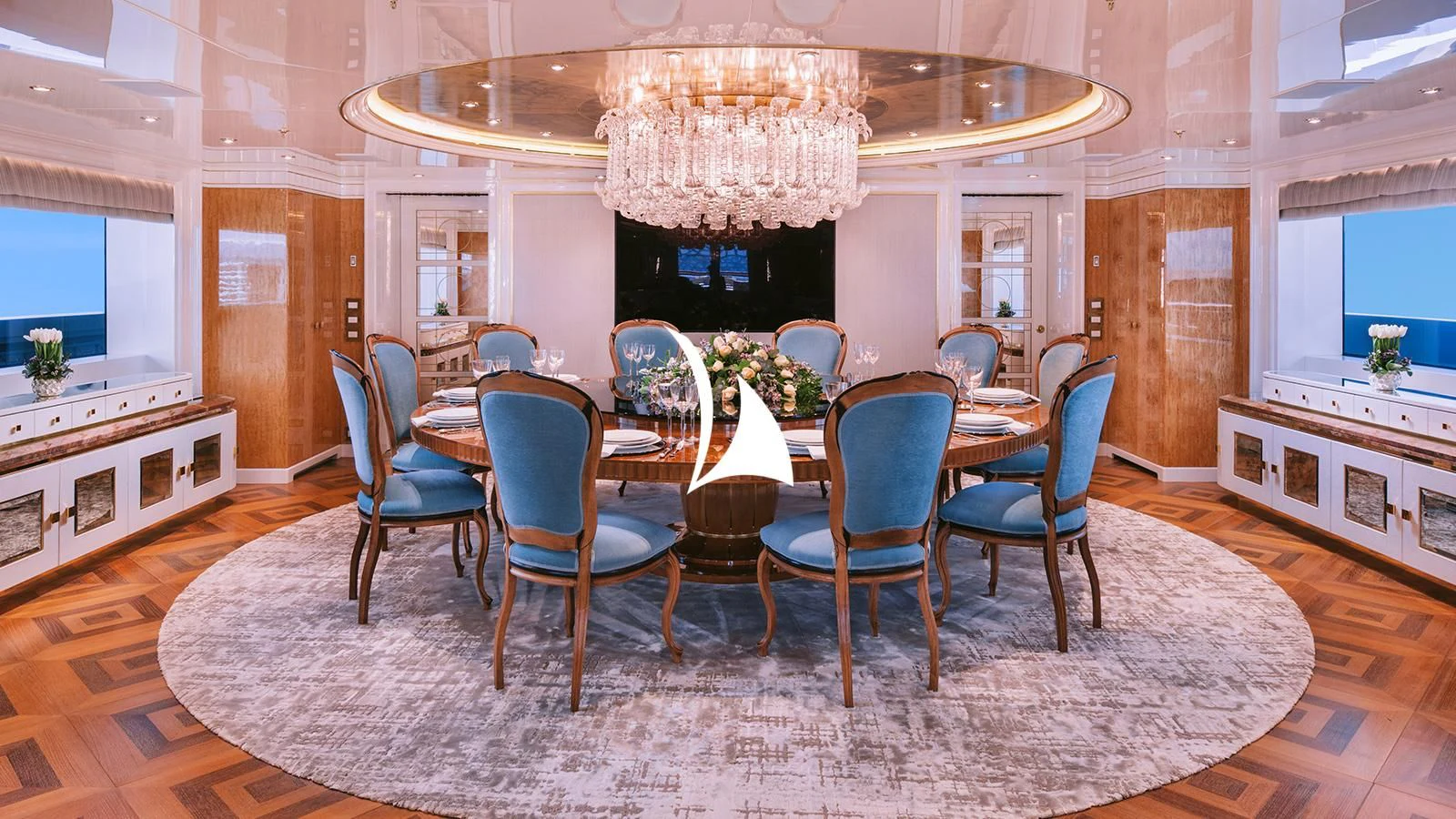 a dining room with a chandelier aboard AELIA Yacht for Sale