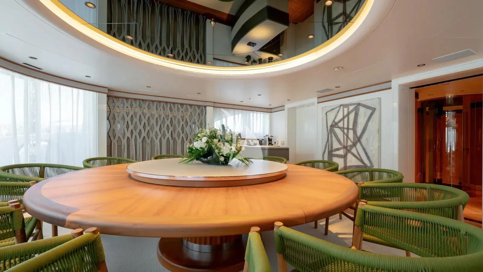 a room with tables and chairs aboard AELIA Yacht for Sale