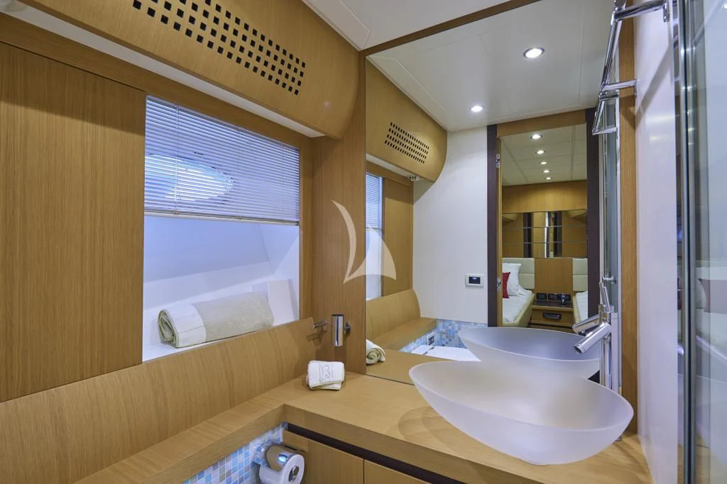 a bathroom with a sink and a mirror aboard DANZAS Yacht for Sale