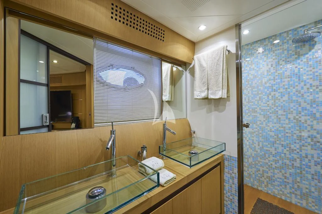a bathroom with a countertop sink and mirror aboard DANZAS Yacht for Sale