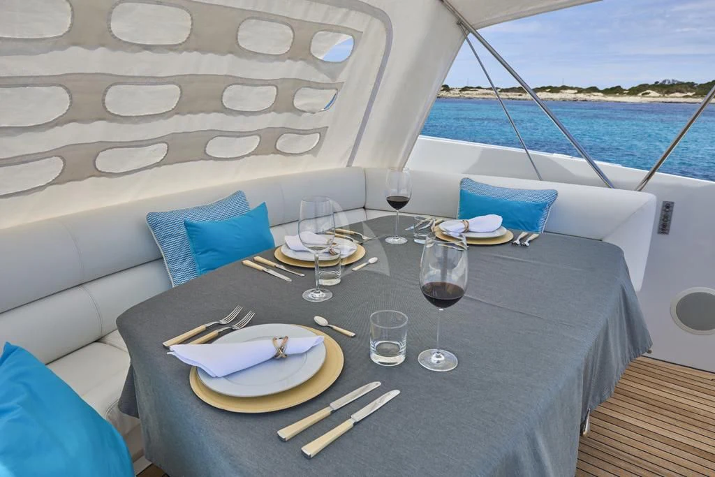 a table with plates and glasses on it aboard DANZAS Yacht for Sale