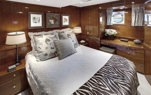 a large bedroom with a large bed aboard ASKARI Yacht for Sale
