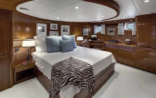 a bedroom with a large bed aboard ASKARI Yacht for Sale