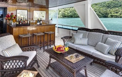 a living room with a table and chairs aboard ASKARI Yacht for Sale