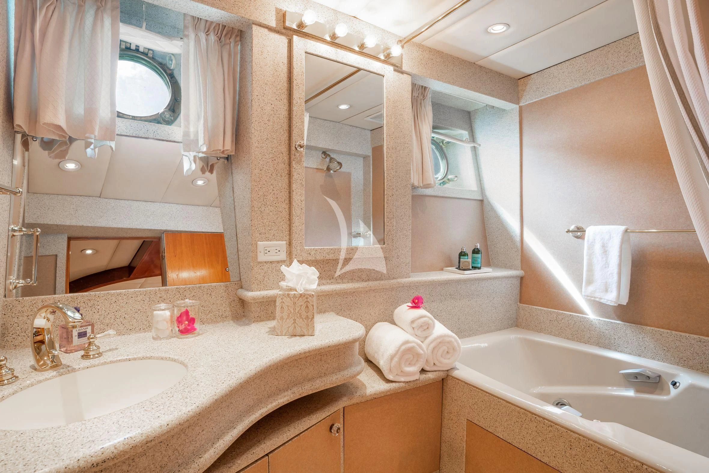 a bathroom with a large mirror aboard ASKARI Yacht for Sale