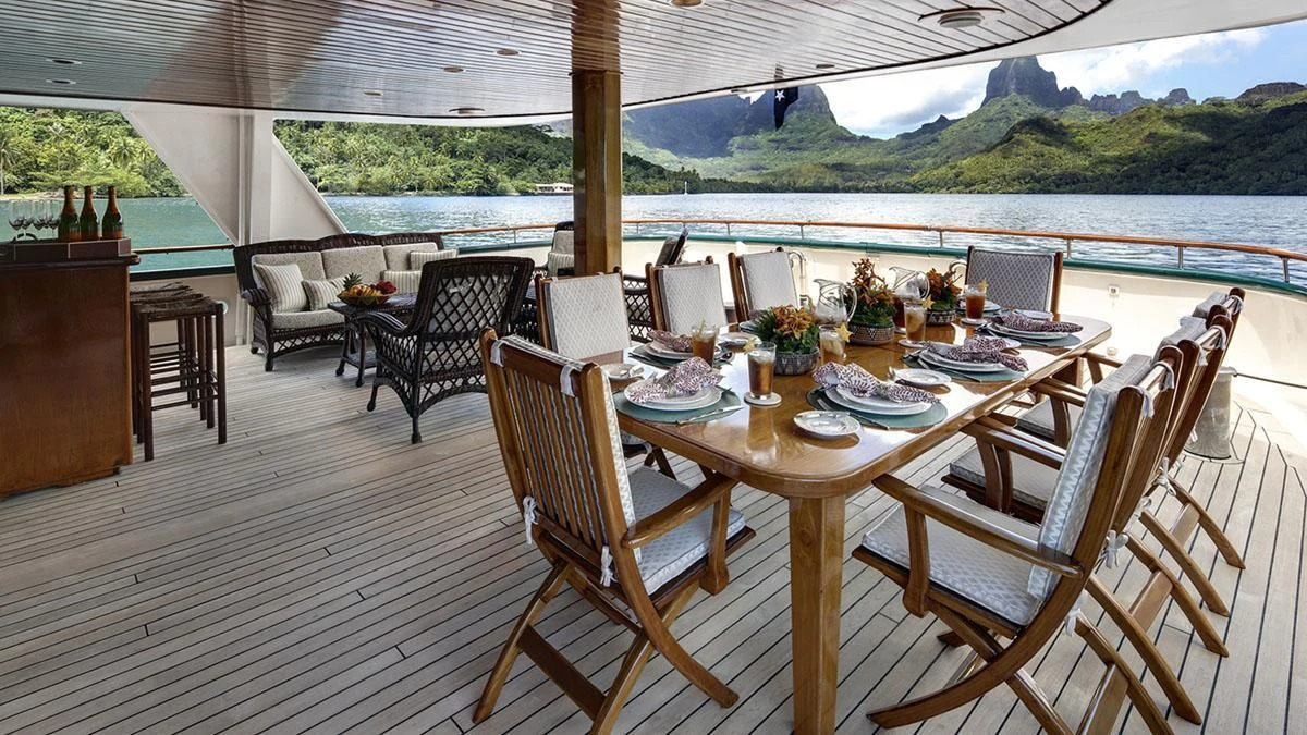 a table set for a meal on a deck aboard ASKARI Yacht for Sale