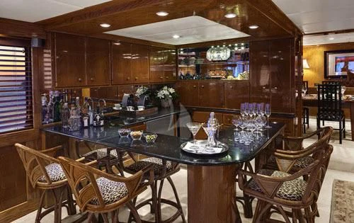 a bar with a table and chairs aboard ASKARI Yacht for Sale