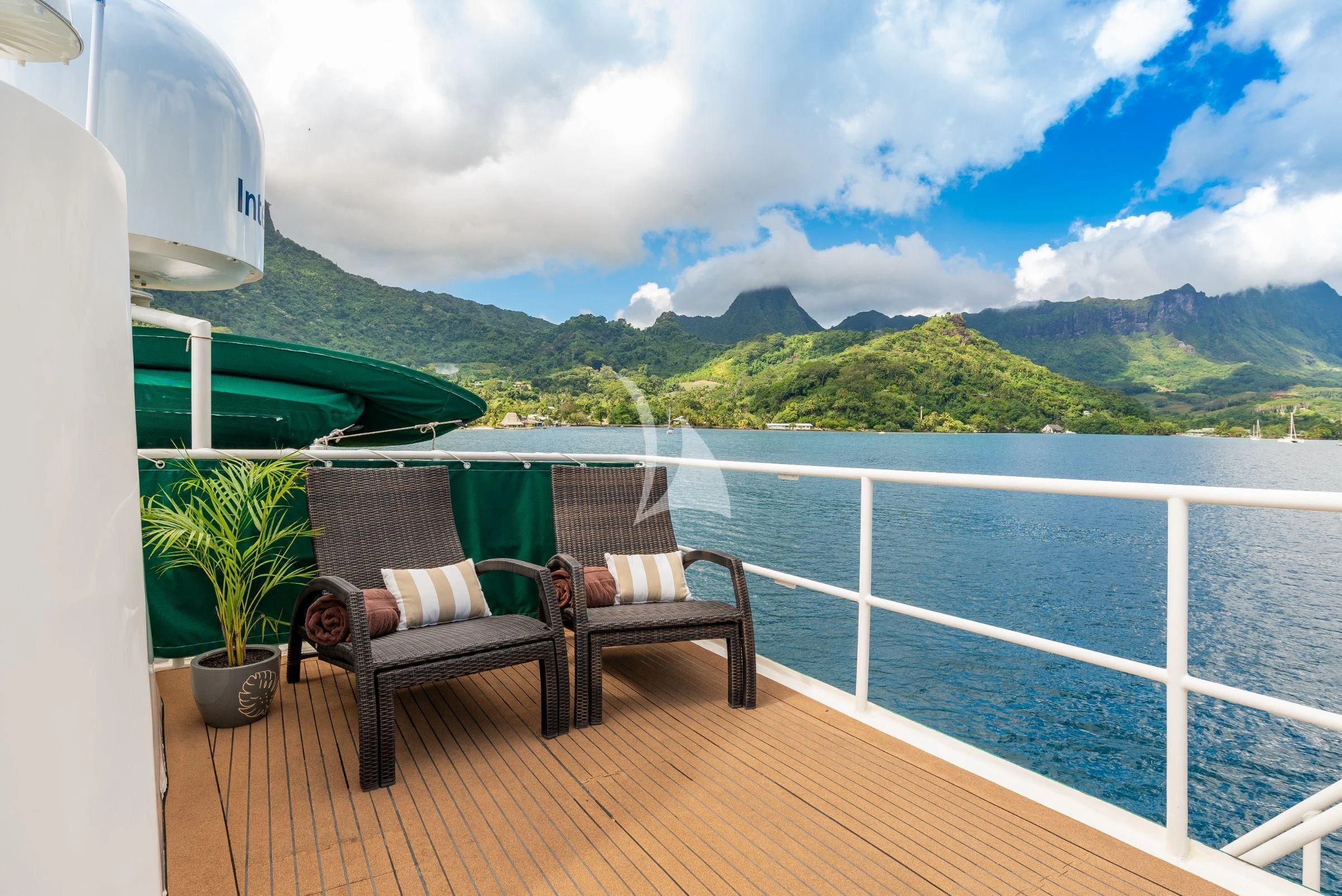 a deck with chairs and a body of water aboard ASKARI Yacht for Sale