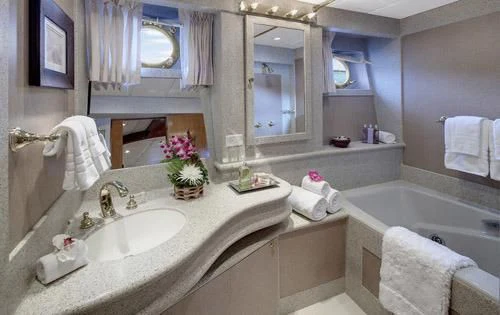 a bathroom with a sink and bathtub aboard ASKARI Yacht for Sale