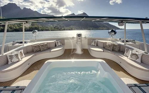 a swimming pool with a view of mountains and water aboard ASKARI Yacht for Sale