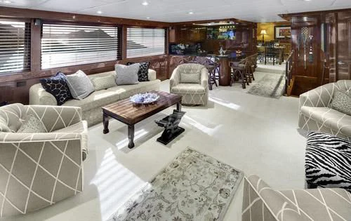 a living room with a couch and a coffee table aboard ASKARI Yacht for Sale