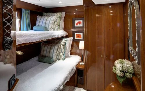 a room with a bed and a wood door aboard ASKARI Yacht for Sale