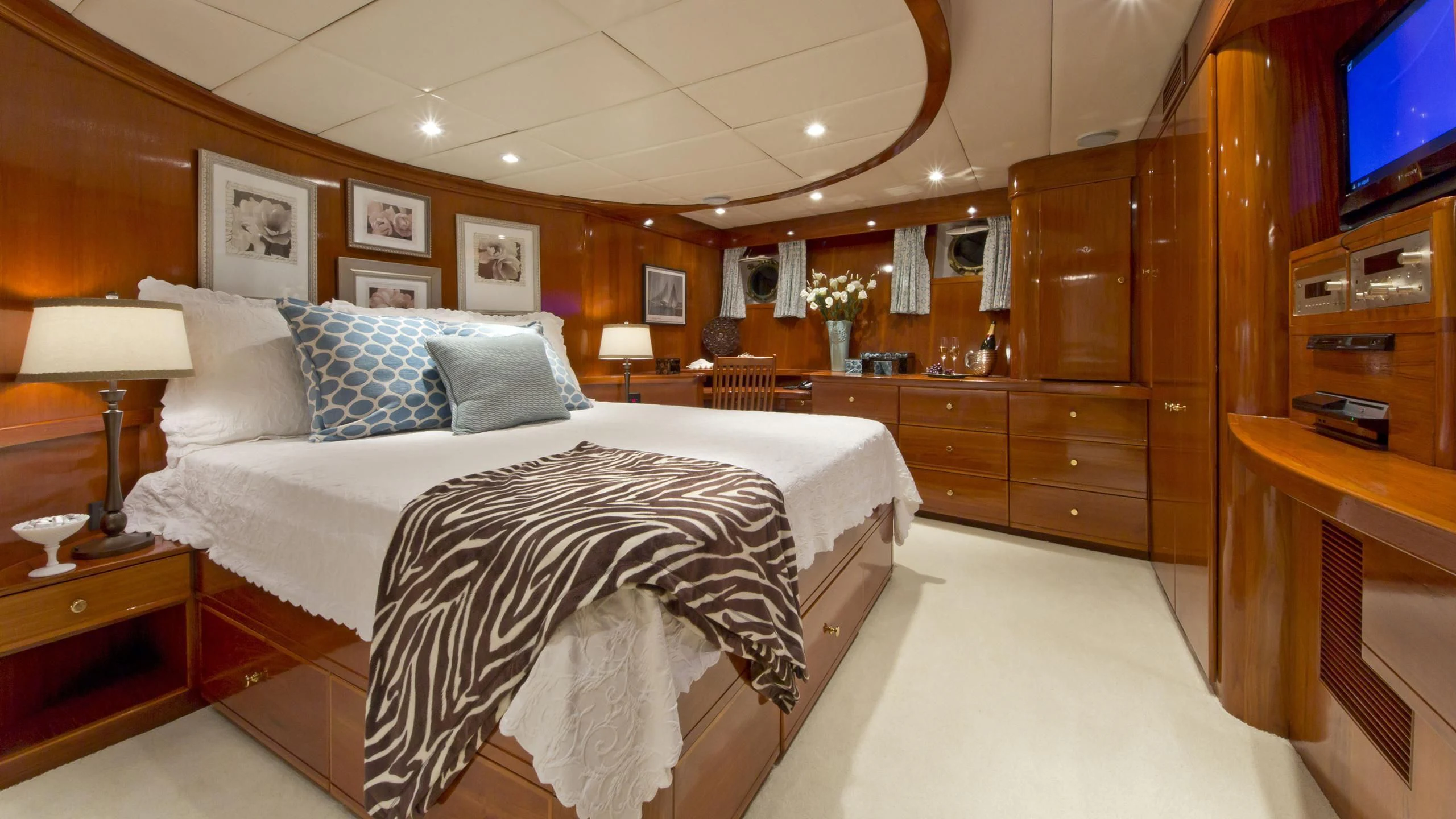 a bedroom with a bed and a desk aboard ASKARI Yacht for Sale