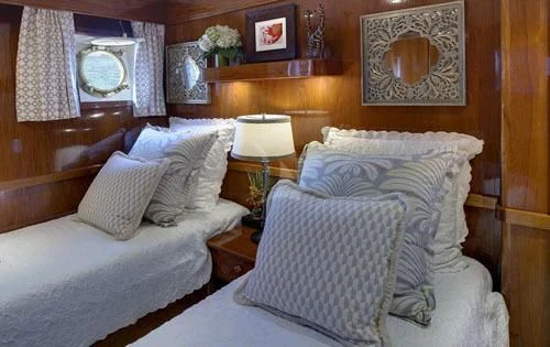 a room with two beds aboard ASKARI Yacht for Sale