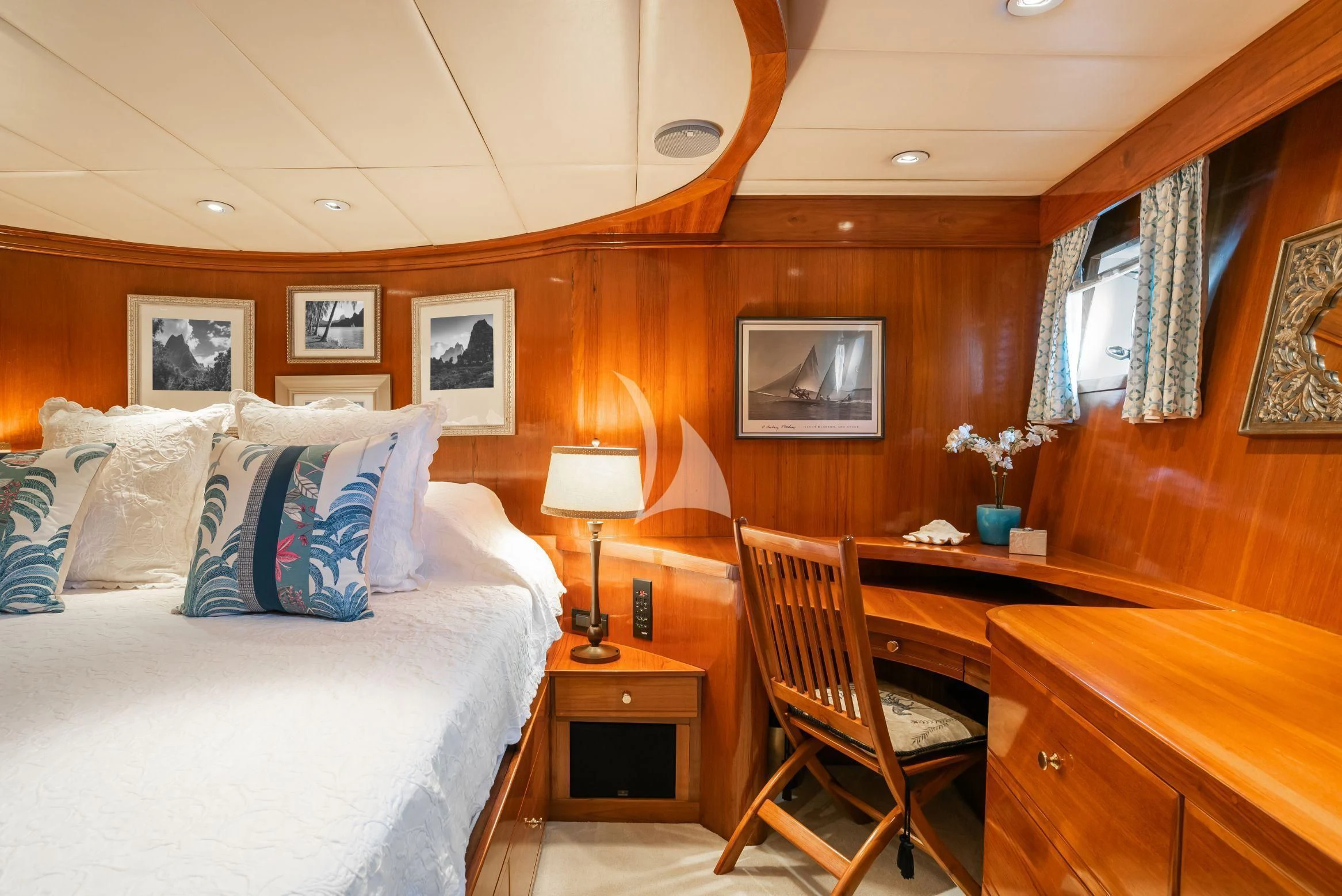 a bedroom with a bed and desk aboard ASKARI Yacht for Sale