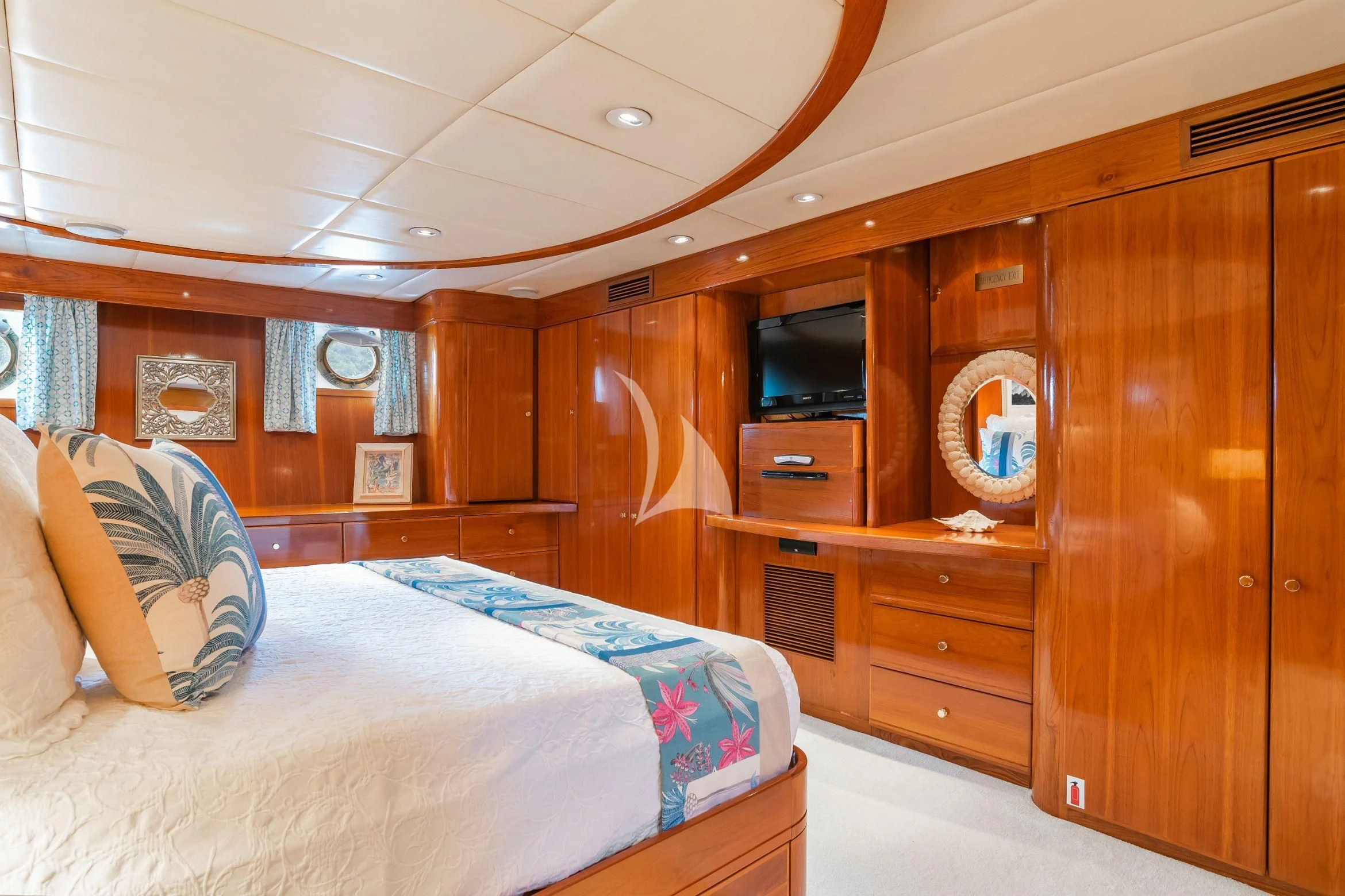 a bedroom with a bed and a television aboard ASKARI Yacht for Sale