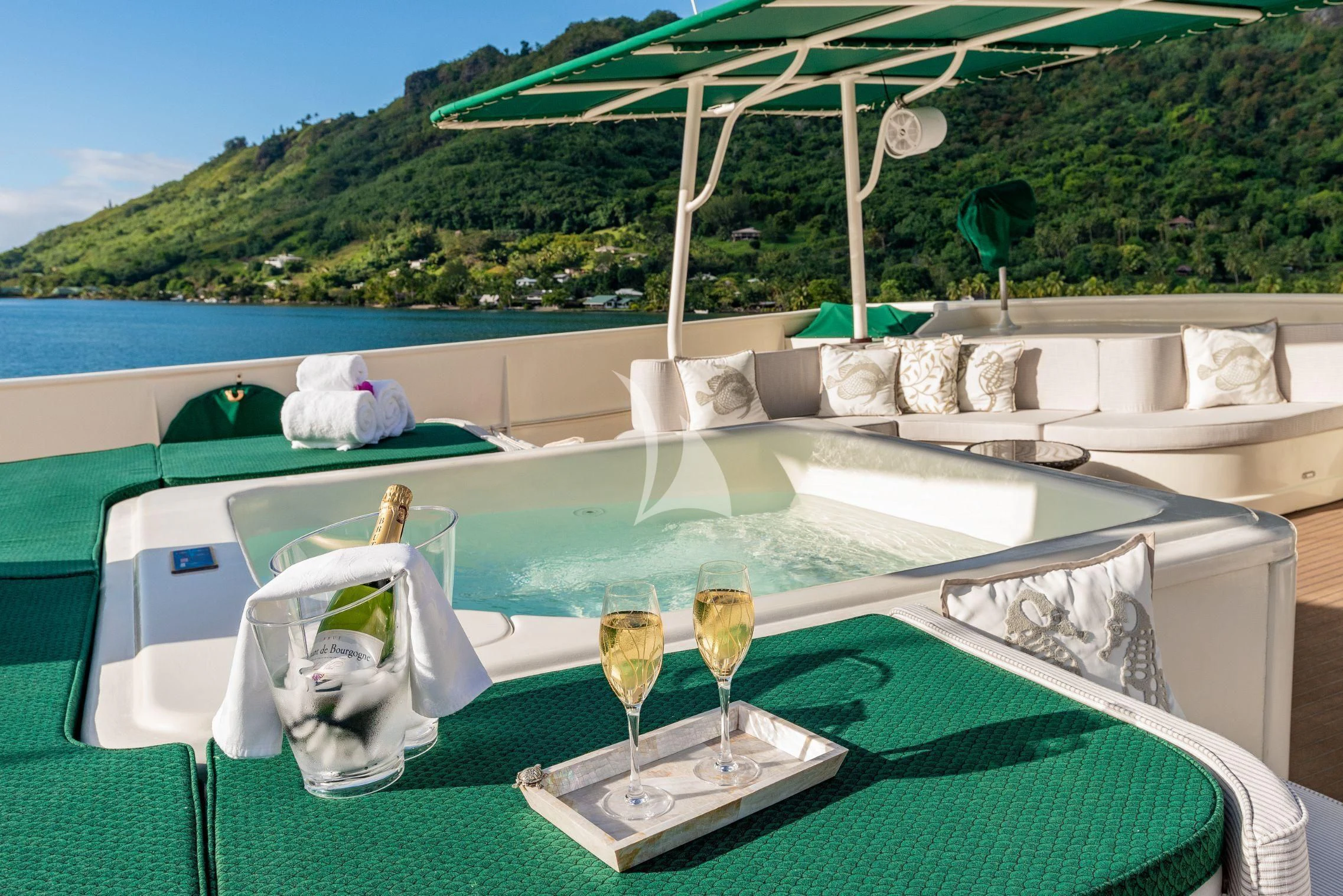 a table with wine glasses and a pool aboard ASKARI Yacht for Sale