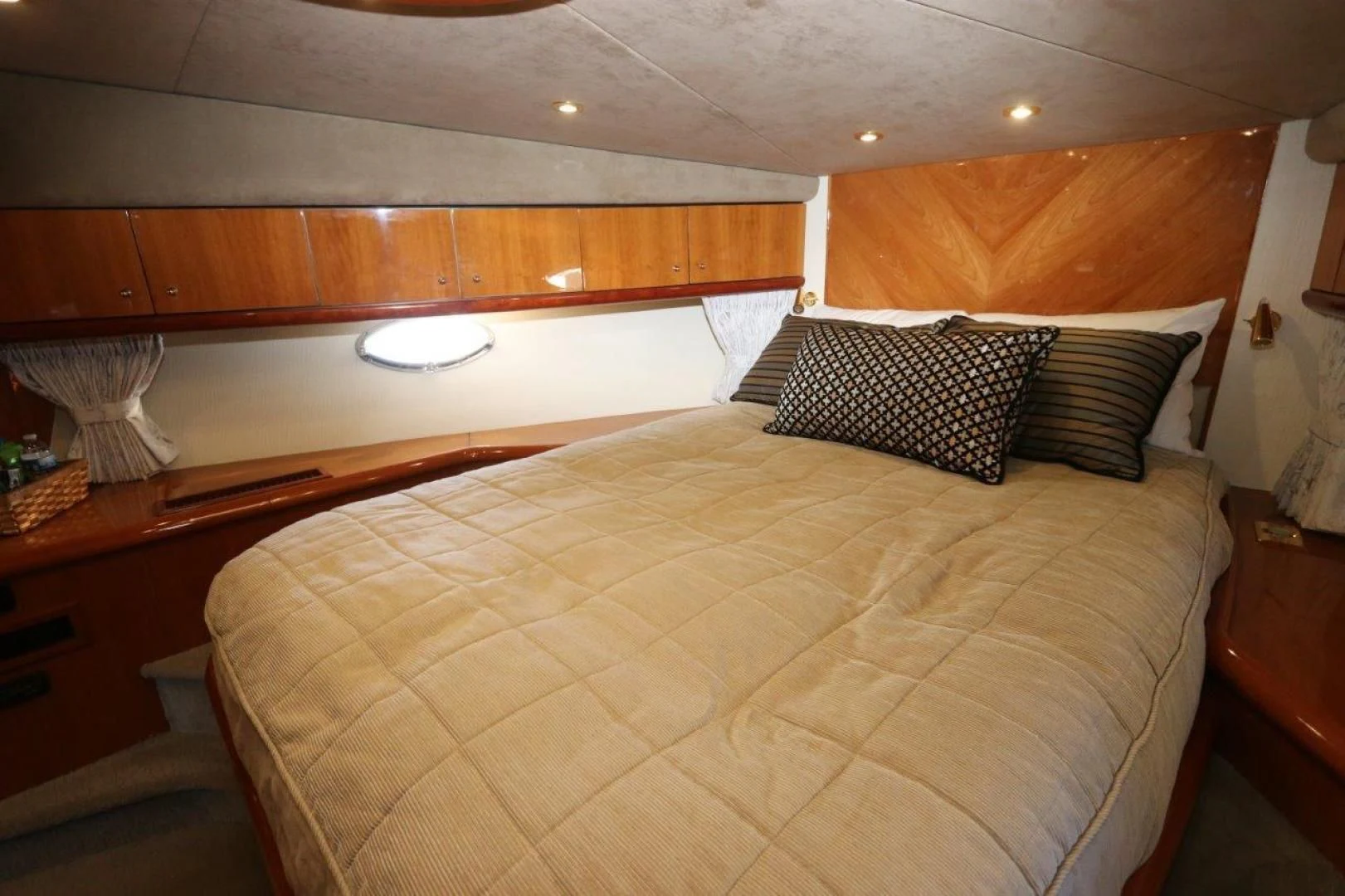 a bed with a yellow comforter aboard SECOND THOUGHTS Yacht for Sale