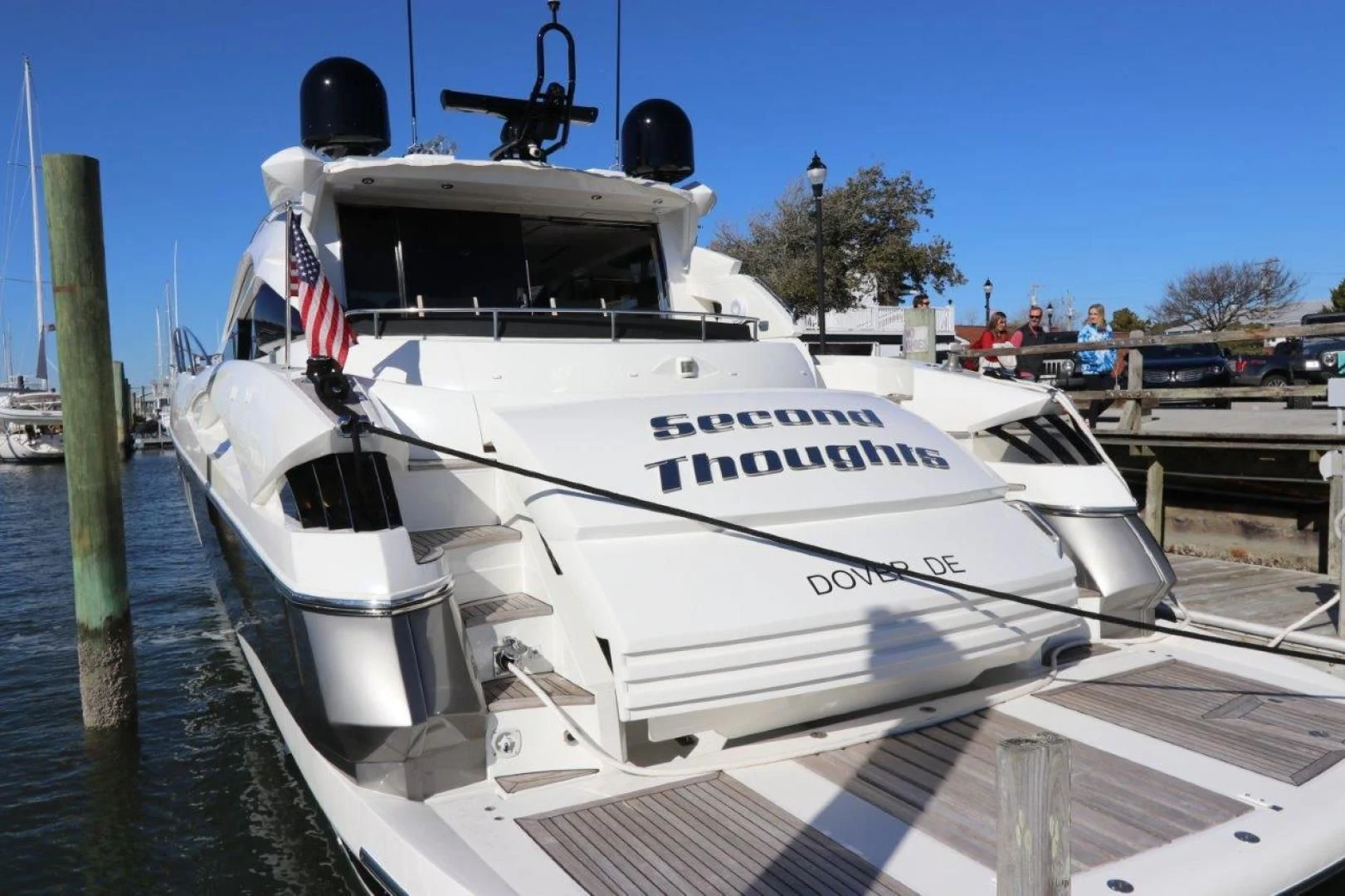 a white yacht docked at a pier aboard SECOND THOUGHTS Yacht for Sale