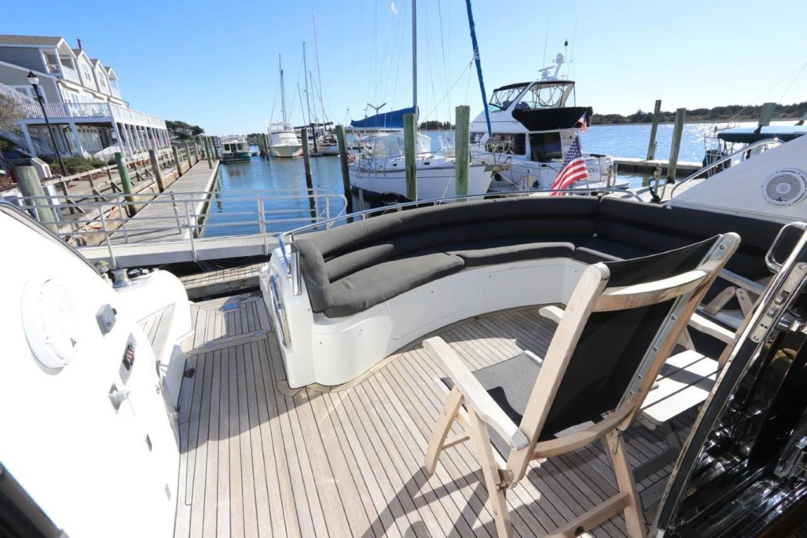a deck with a chair and a boat on it aboard SECOND THOUGHTS Yacht for Sale