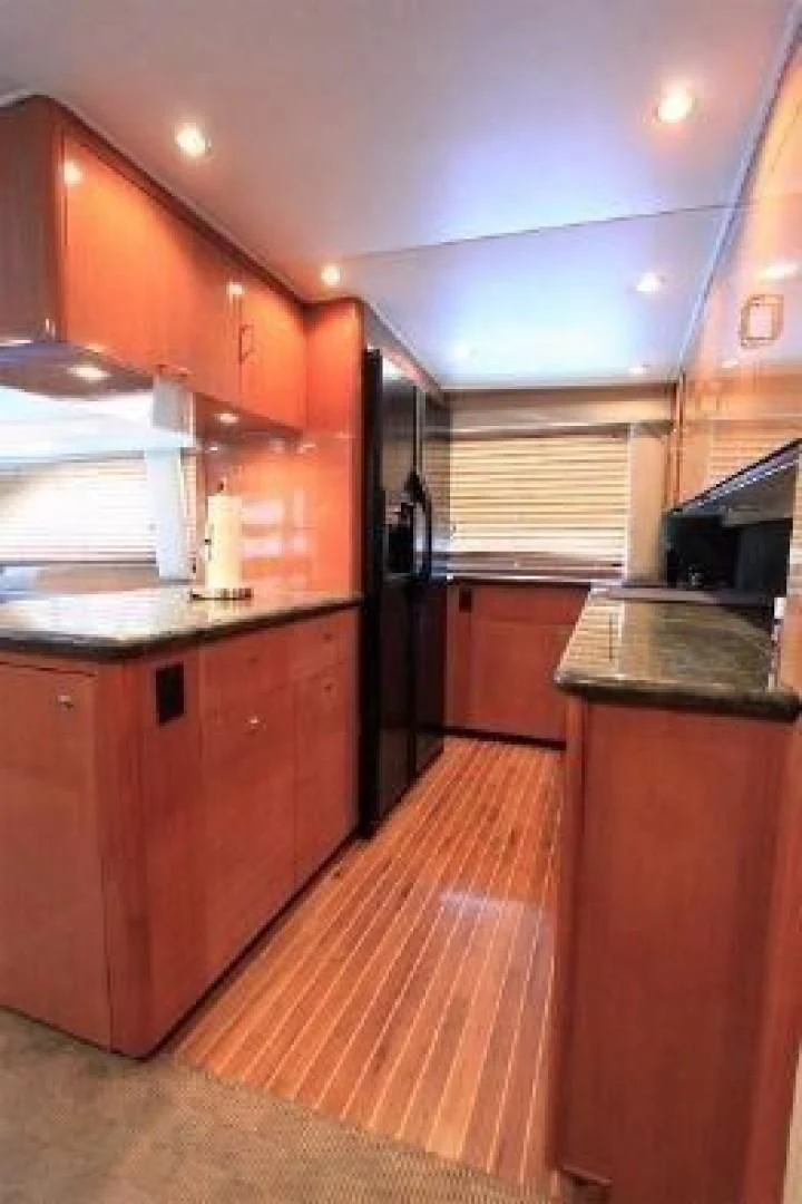 a kitchen with wooden cabinets aboard BROKYSTONE Yacht for Sale