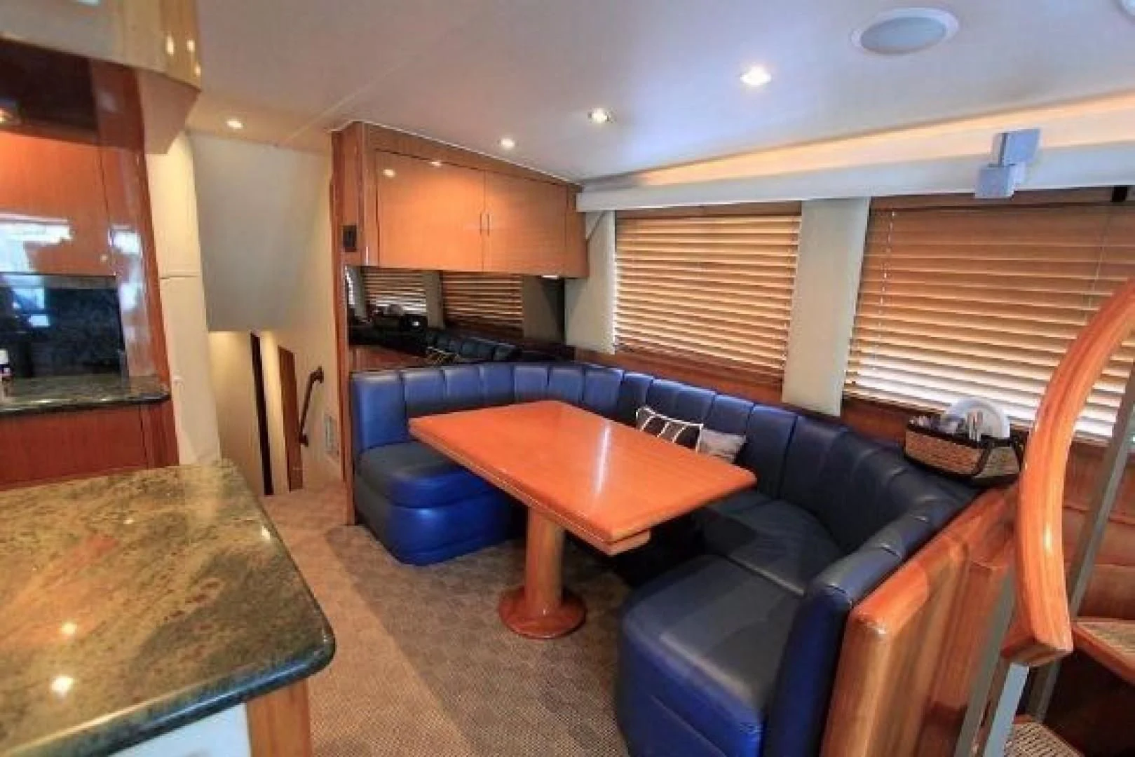 a kitchen with a blue couch aboard BROKYSTONE Yacht for Sale