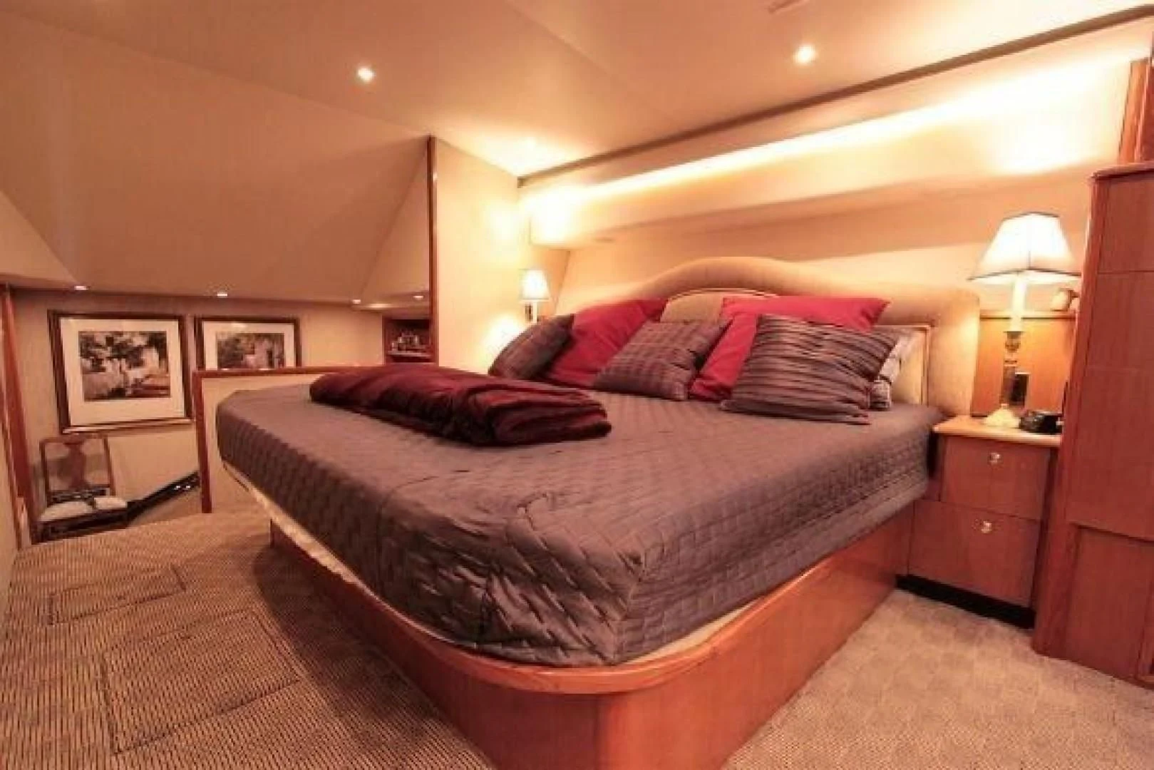 a bed with a red pillow aboard BROKYSTONE Yacht for Sale
