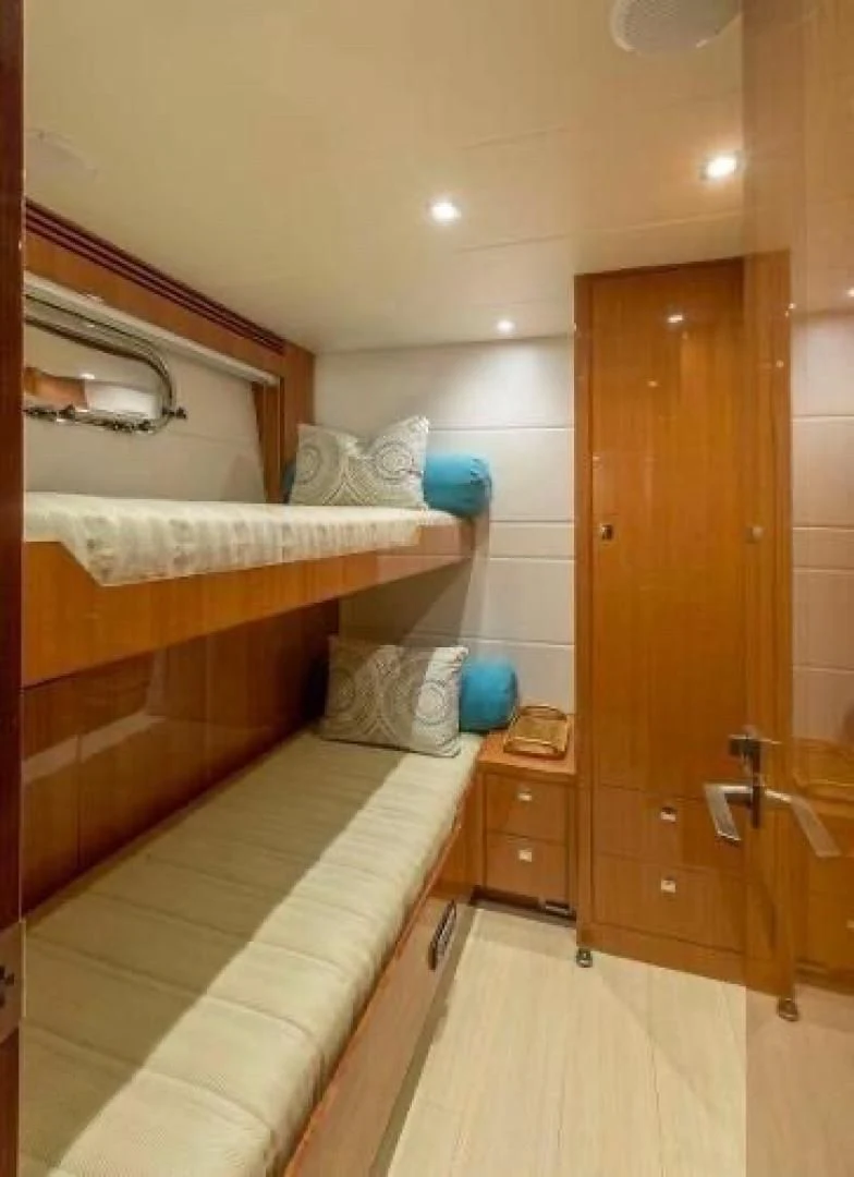 a room with a bed and a closet aboard FUJIMO Yacht for Sale