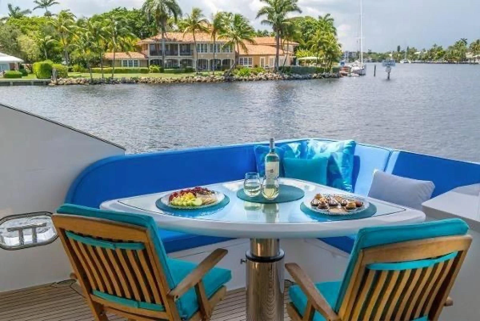 a table with food on it by a body of water aboard FUJIMO Yacht for Sale