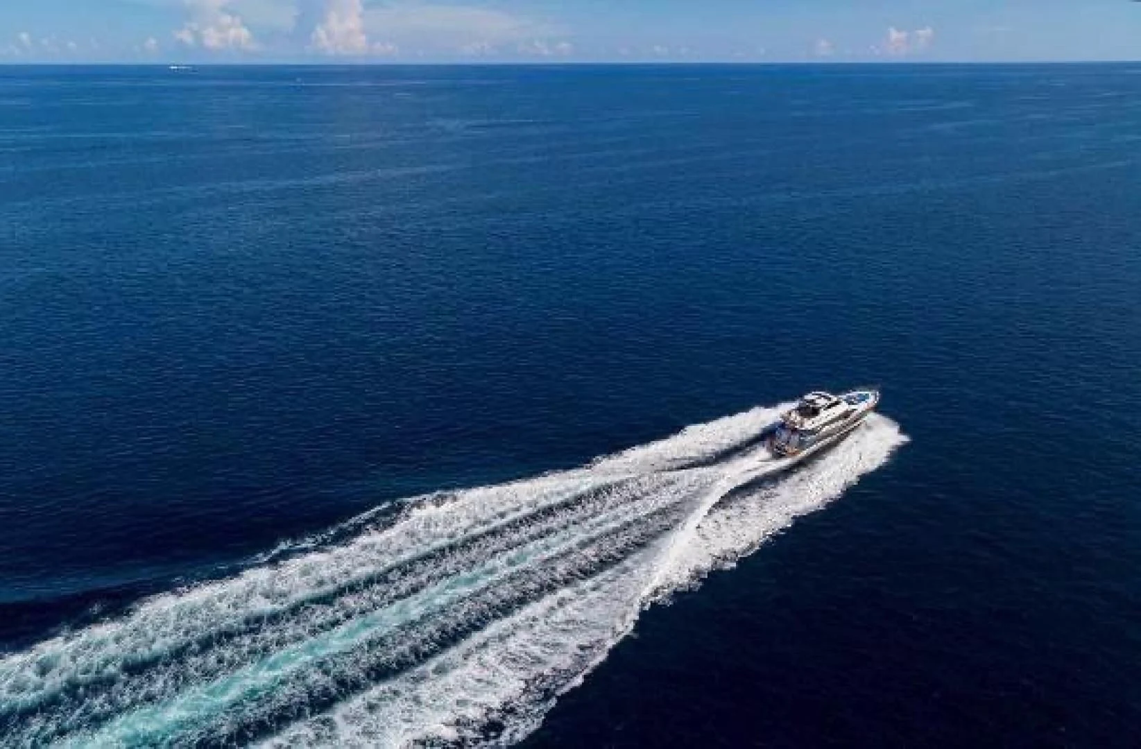 a large body of water with a road and a beach in the background aboard FUJIMO Yacht for Sale