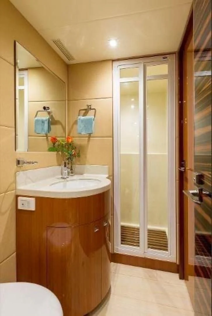 a bathroom with a glass shower door aboard FUJIMO Yacht for Sale