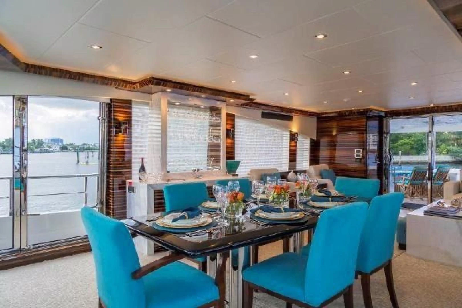 a dining room with blue chairs aboard FUJIMO Yacht for Sale
