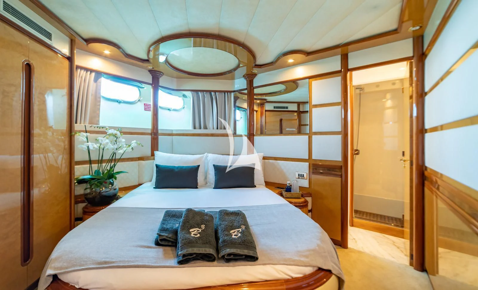 a bed with a laptop on it aboard IRMAO Yacht for Sale