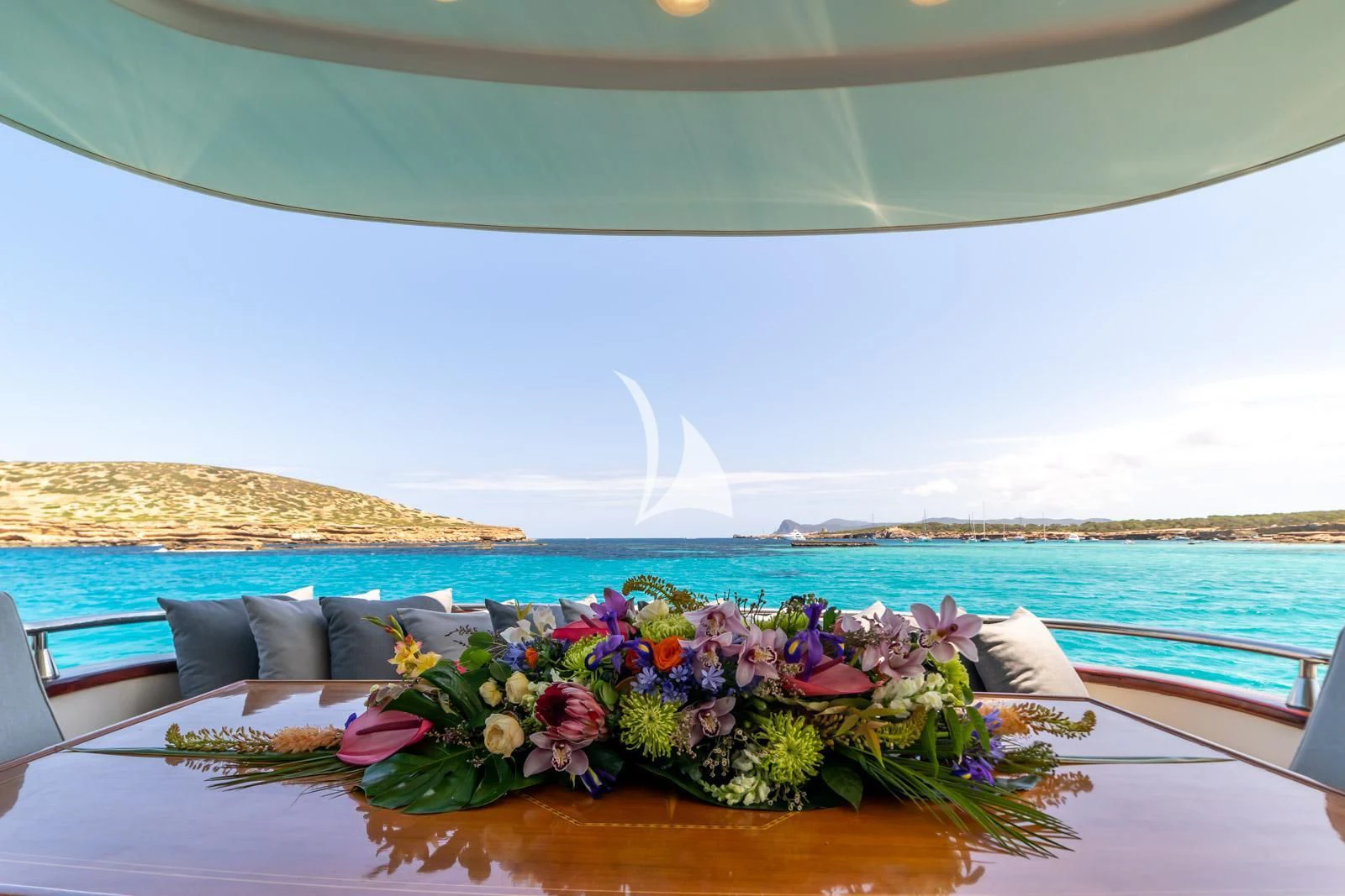 a table with flowers on it aboard IRMAO Yacht for Sale