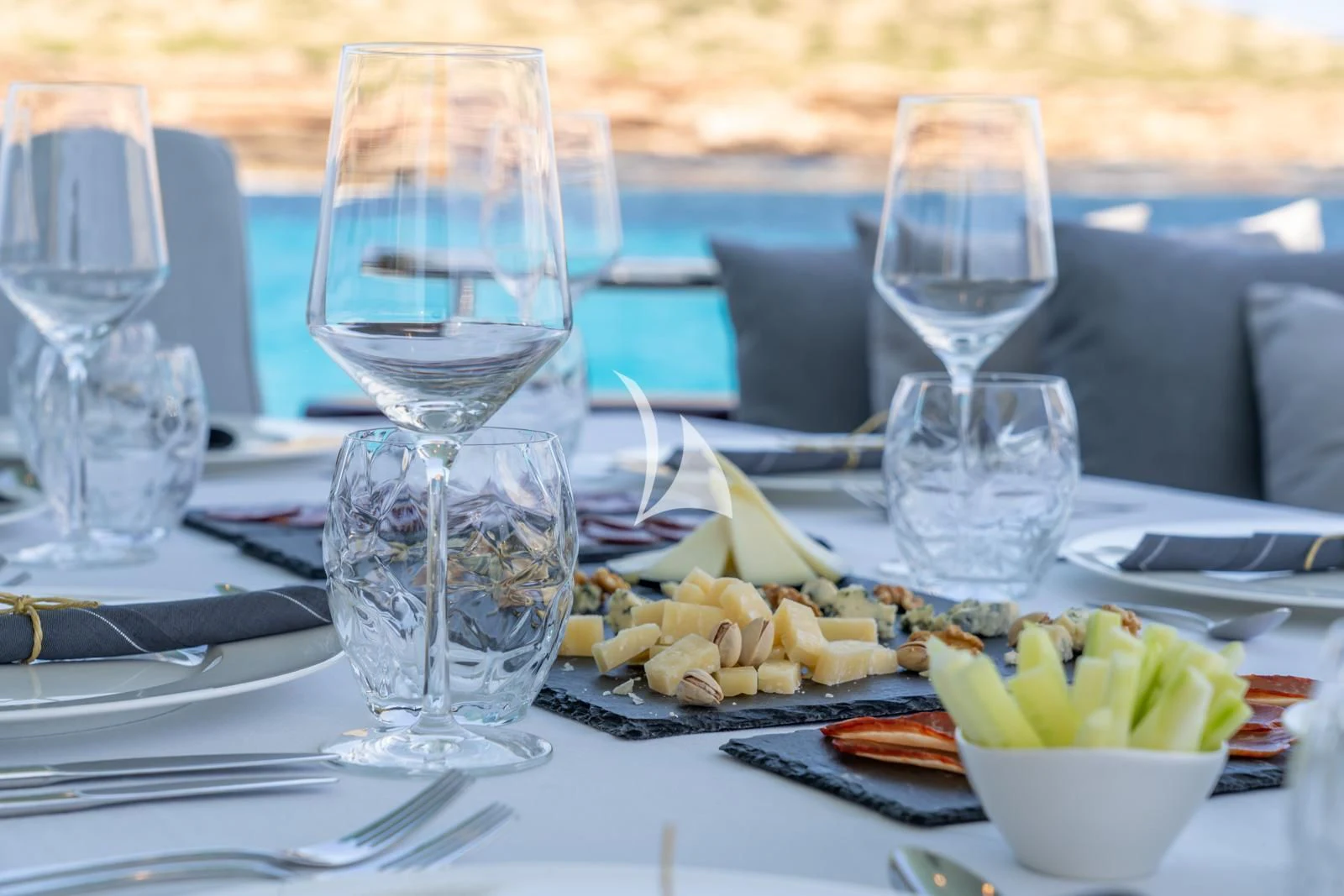 a table with food and glasses aboard IRMAO Yacht for Sale