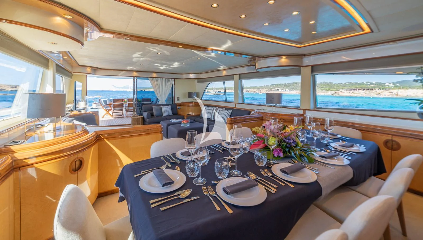 a dining room with a large window aboard IRMAO Yacht for Sale