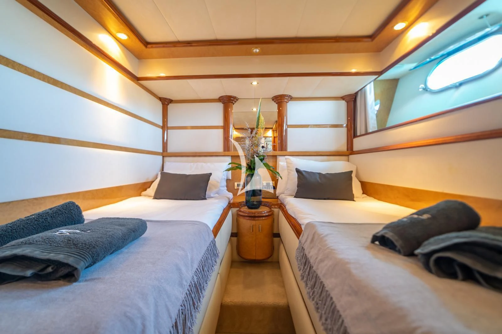 a room with beds and a plant aboard IRMAO Yacht for Sale