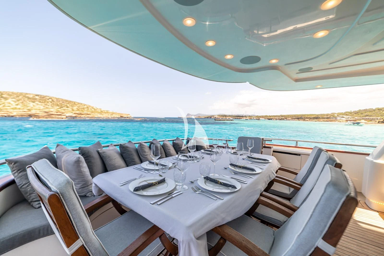 a table set for a dinner on a boat aboard IRMAO Yacht for Sale