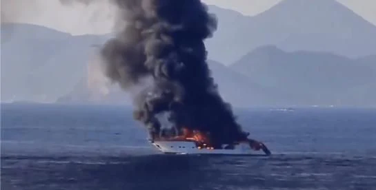 a large wave crashing into a boat aboard IRMAO Yacht for Sale