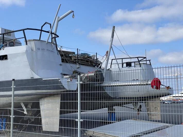 a white boat with a red flag on it aboard SABRINA Yacht for Sale