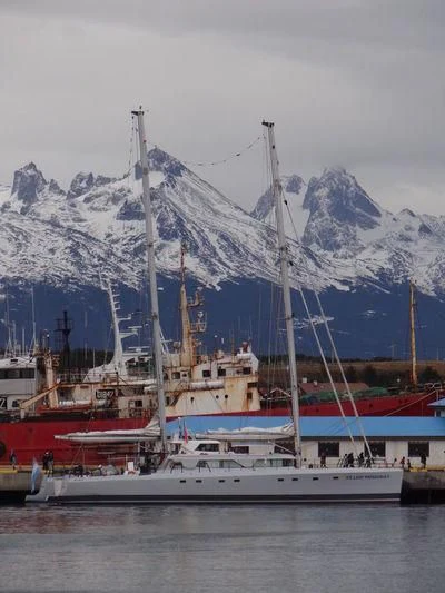 a boat docked in front of a mountain aboard SABRINA Yacht for Sale