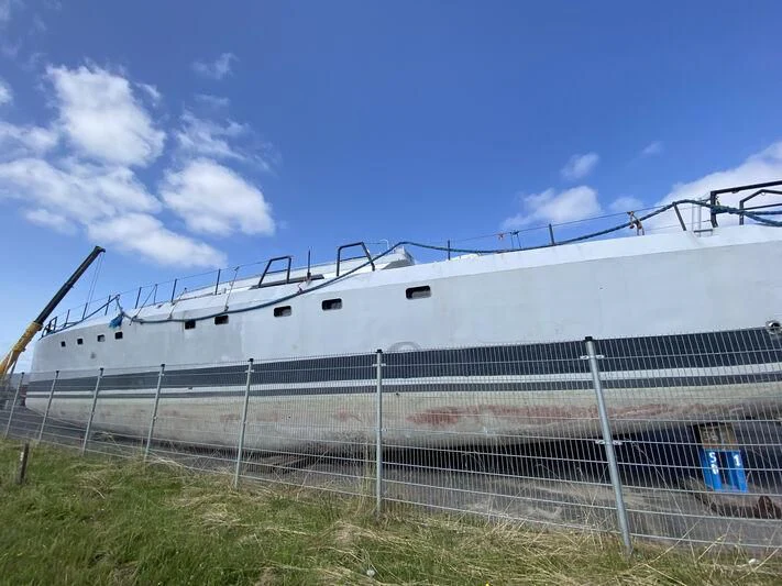 a large white boat in a grassy area aboard SABRINA Yacht for Sale