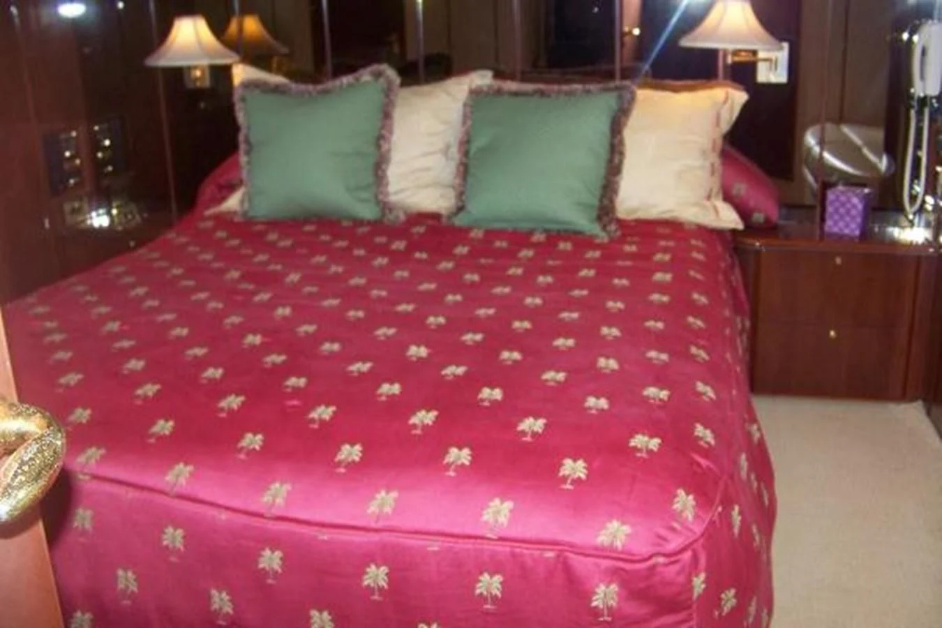 a bed with a red comforter aboard KAILANI Yacht for Sale
