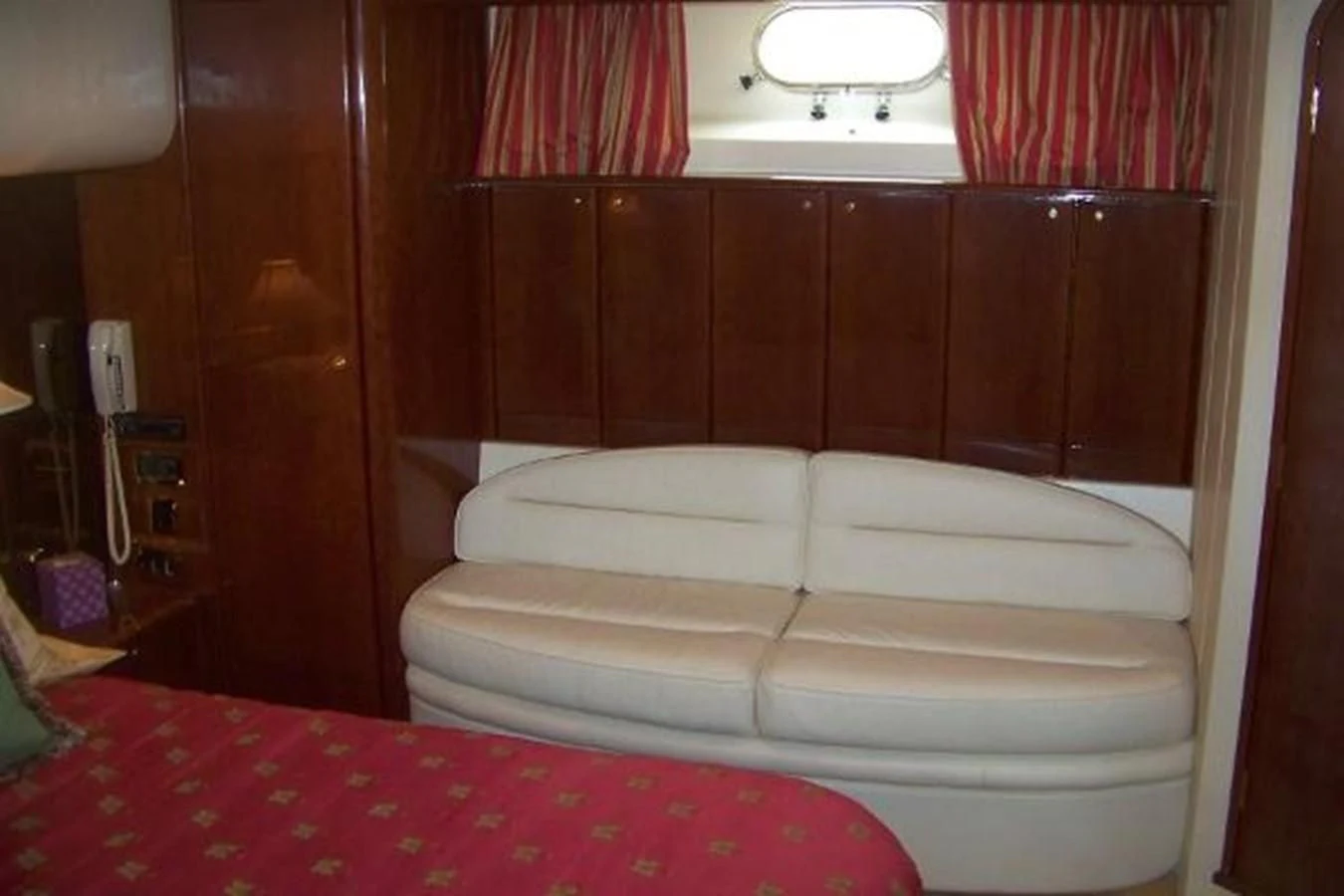 a bed with a red sheet aboard KAILANI Yacht for Sale