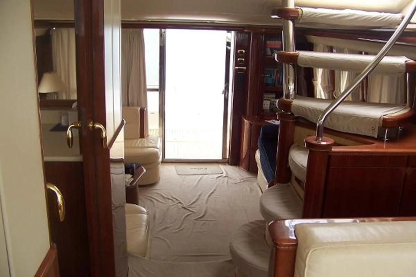 a room with a bed and desk aboard KAILANI Yacht for Sale