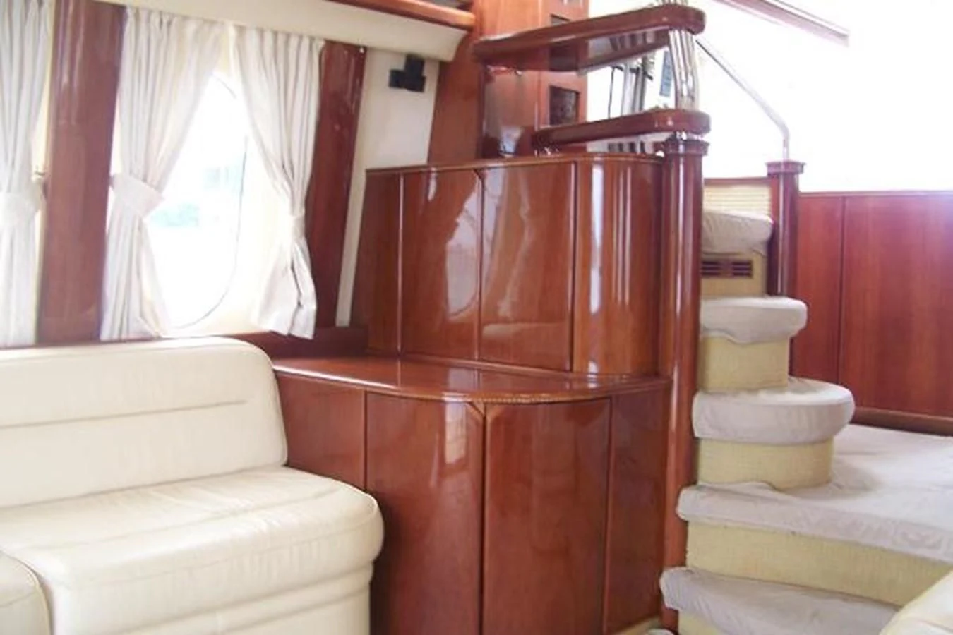 a wooden staircase with a white couch aboard KAILANI Yacht for Sale