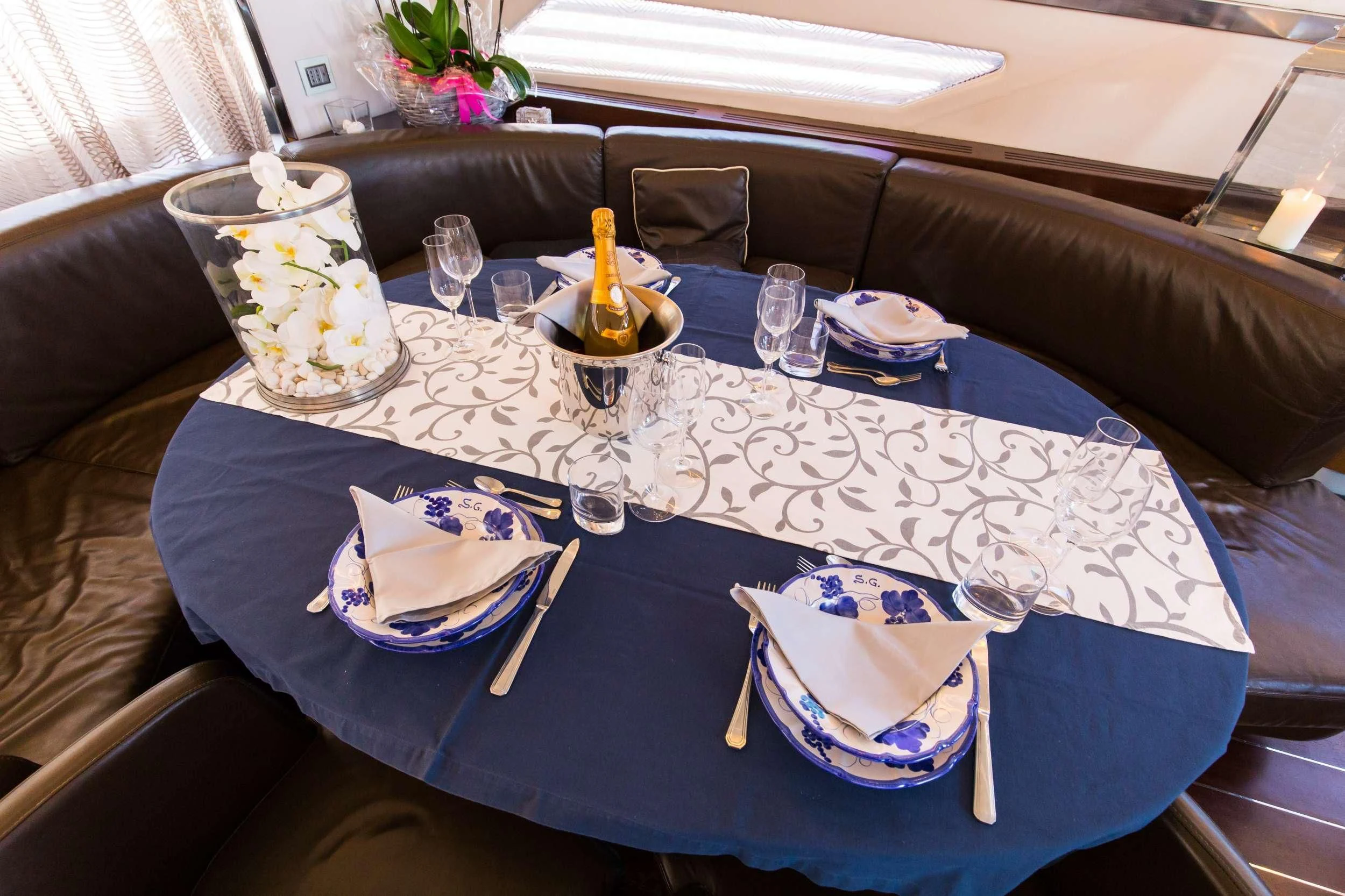 a table with plates and silverware aboard CINQUE Yacht for Sale