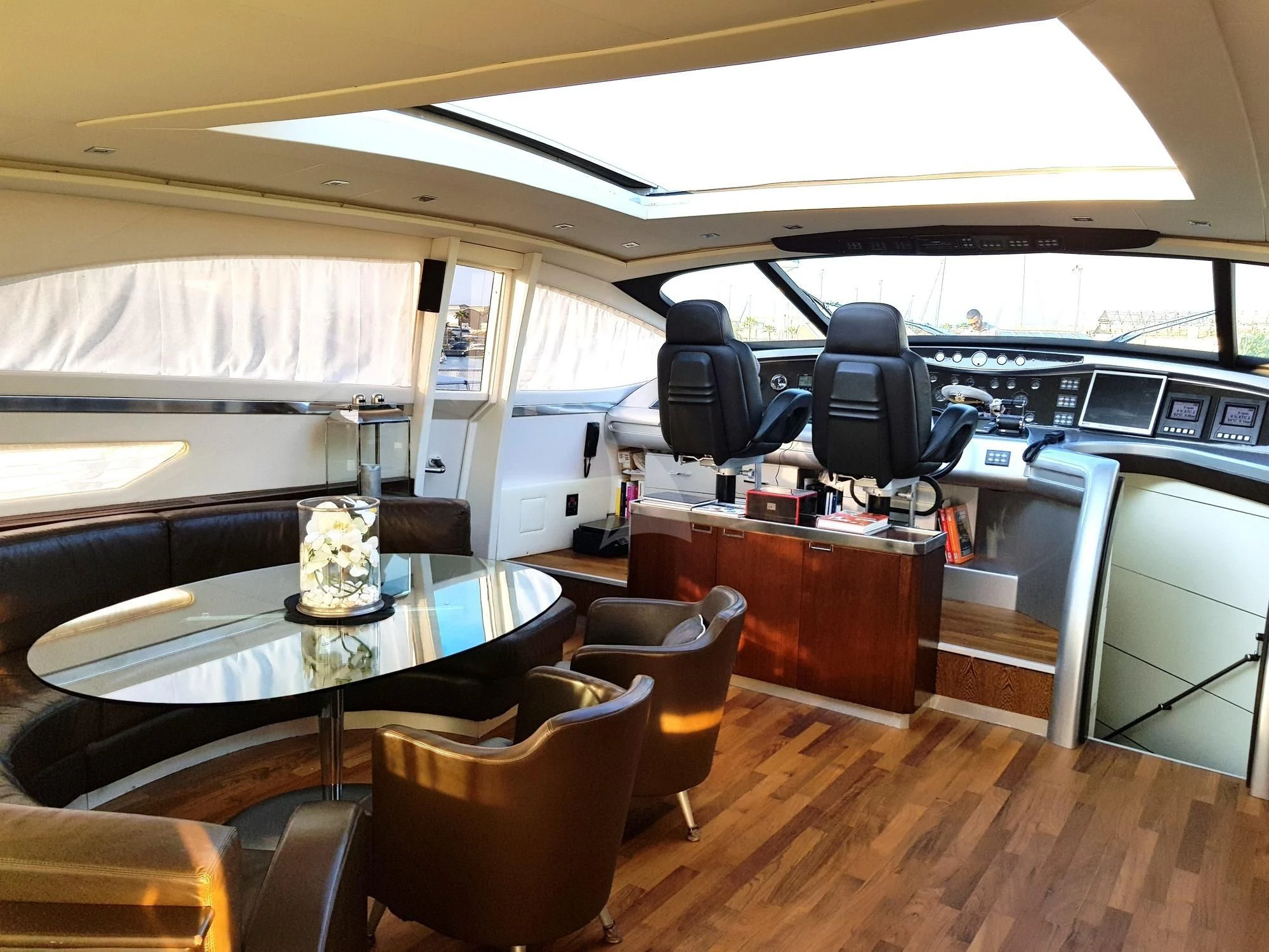 inside of a vehicle with a table and chairs and a bench aboard CINQUE Yacht for Sale